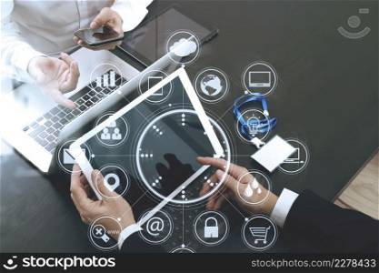 co working team meeting concept,businessman using smart phone and digital tablet and laptop computer and name tag in modern office with virtual icon graph and chart