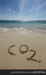 CO2 on a beach. CO2 handwritten in sand on a tropical beach