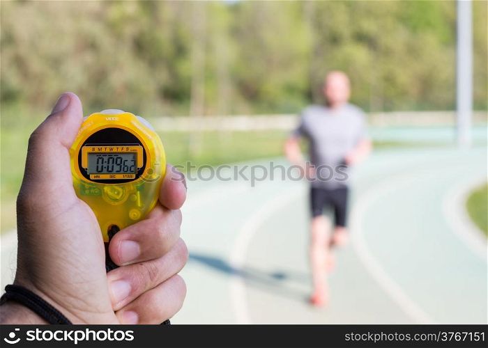 Coach clocking times in a running track