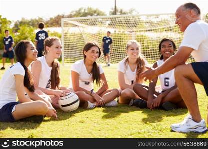 Coach Giving Team Talk To Female High School Soccer Team
