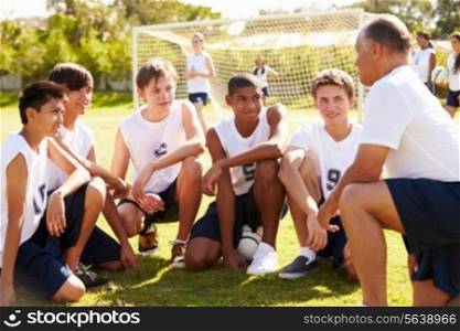 Coach Giving Team Talk To Male High School Soccer Team