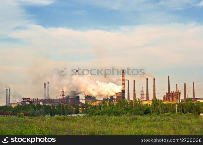 Coal burning power plant surrounded by a smoggy sky