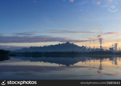 Coal power plant and water reflection in the morning among the mountains and lakes. Mae Moh, Lampang, Thailand.. Coal power plant and lake.