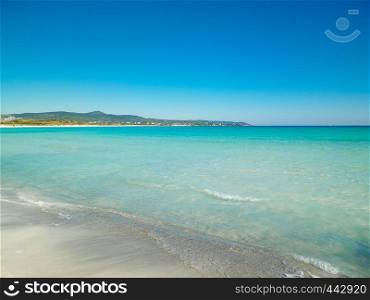 Coast and beach in Vada, Italy. Transparent, turquoise water and white sand. Travel and nature concept.. Blue water of Tyrrhenian sea in Vada, Tuscany, Italy.