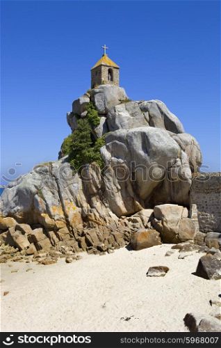 Coast of France in Brittany, the famous small chapel at the rocks in Port-Blanc