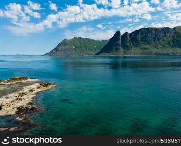 Coast of Gimsoya island in summertime. Sea with mountains. Nordland county, Lofoten archipelago Norway. Tourist attraction.. Seascape on Gimsoya island, Lofoten Norway