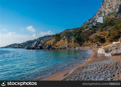 Coast of the sea bay, surrounded by mountains, sunny seascape