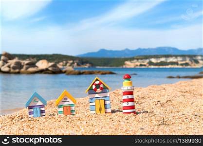Coast with miniature wooden village and light house