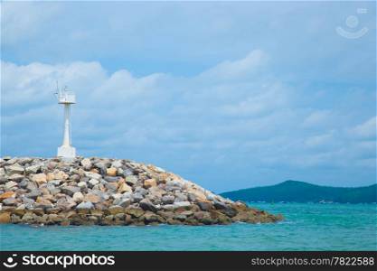 Coastal areas lighthouse. On coastal rocks to roll out into the sea.