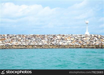 Coastal areas lighthouse. On coastal rocks to roll out into the sea.