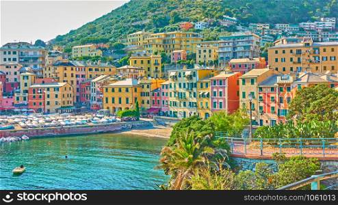 Coastal italian town - Waterfront with buildings by the sea in Genoa Nervi in the summer evening