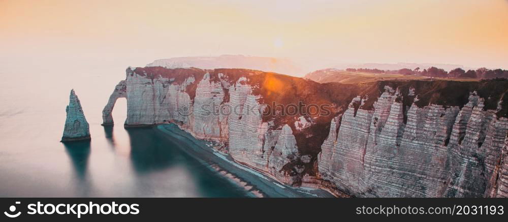 coastal landscape along the Falaise d&rsquo;Aval the famous white cliffs of Etretat village with the Porte d&rsquo;Aval natural arch and the rock known as the Aiguille d&rsquo;Etretat