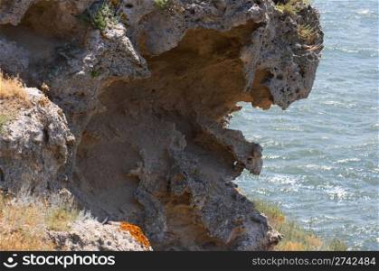 Coastal stony cliff with quaint weathering forms