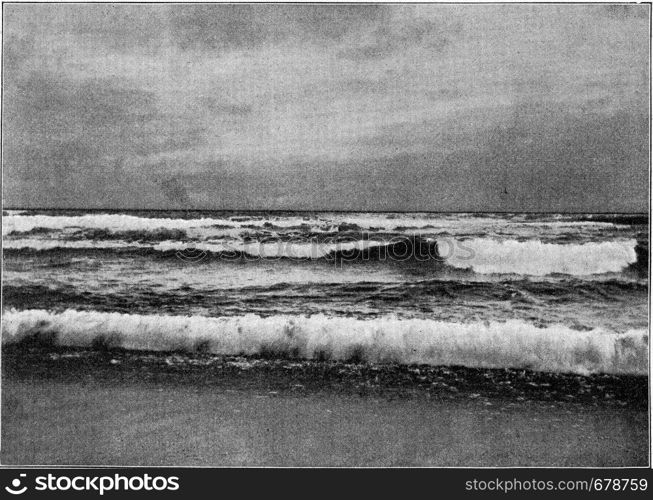 Coastal surf, vintage engraved illustration. From the Universe and Humanity, 1910.