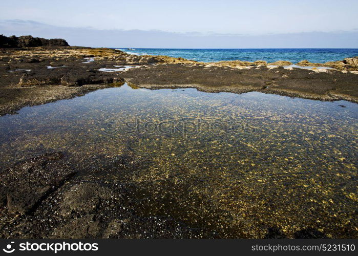 coastline in lanzarote spain pond rock stone sky cloud beach water musk and summer