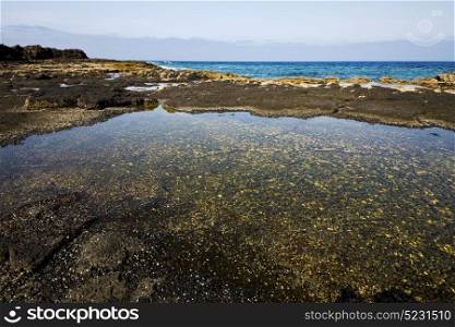 coastline in lanzarote spain pond rock stone sky cloud beach water musk and summer