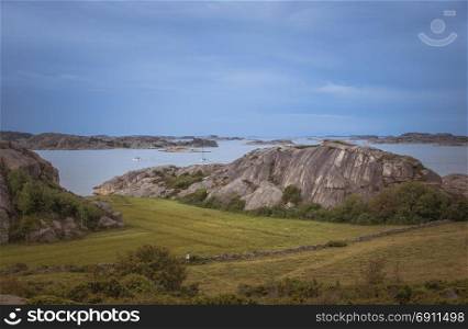coastline in sweden above fjallbacka with boats and sea as background