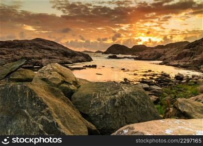 Coastline near Lindesnes lighthouse at beautuful sunset, South Cape, Vest-Agder, Norway. Coastline at sunset in Norway