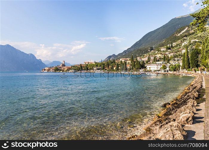 Coastline of lago di garda: Blue water and little village Malcesine