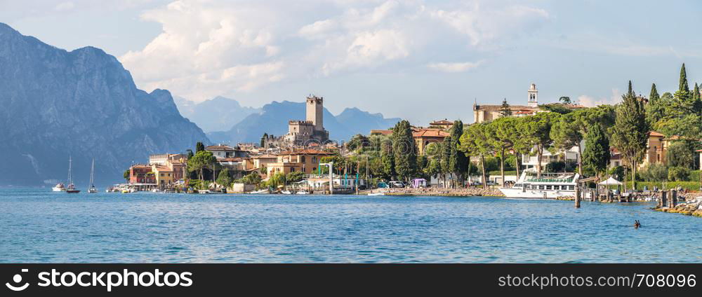 Coastline of lago di garda: Blue water and little village Malcesine