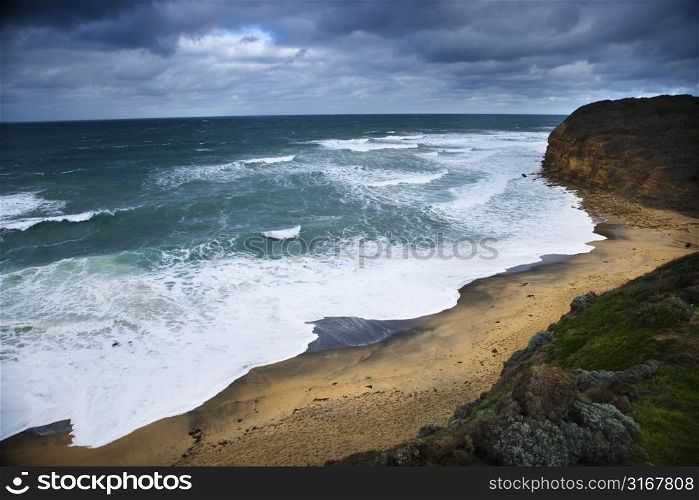 Coastline with waves and rocky shore as seen from Great Ocean Road in Australia.
