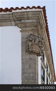 Coat of arms on the corner of a building in Braganca, Portugal