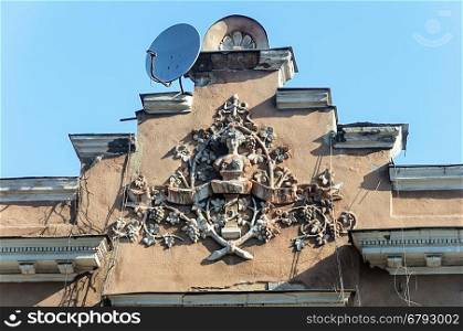 Coat of arms on the pediment of old building in Odessa, Ukraine