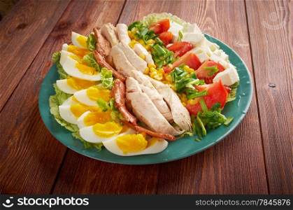 Cobb Salad - Colorful hearty entree sized salad with bacon, chicken, boiled eggs, corn, - a main-dish American garden salad
