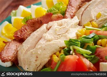 Cobb Salad - Colorful hearty entree sized salad with bacon, chicken, boiled eggs, corn, - a main-dish American garden salad