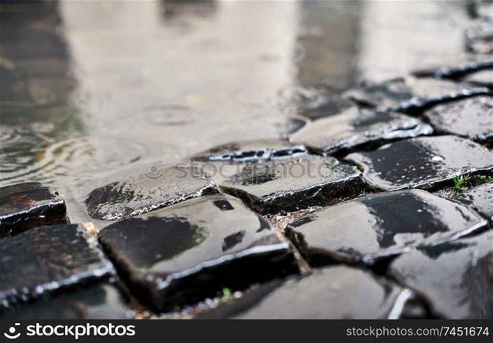 Cobblestone brick paved wet street in Rome, Italy
