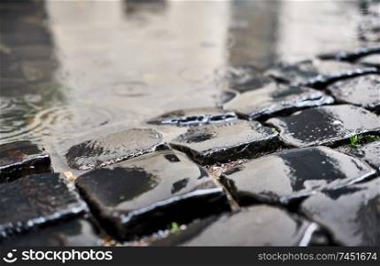 Cobblestone brick paved wet street in Rome, Italy