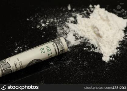 Cocaine and rolled hundred on black background