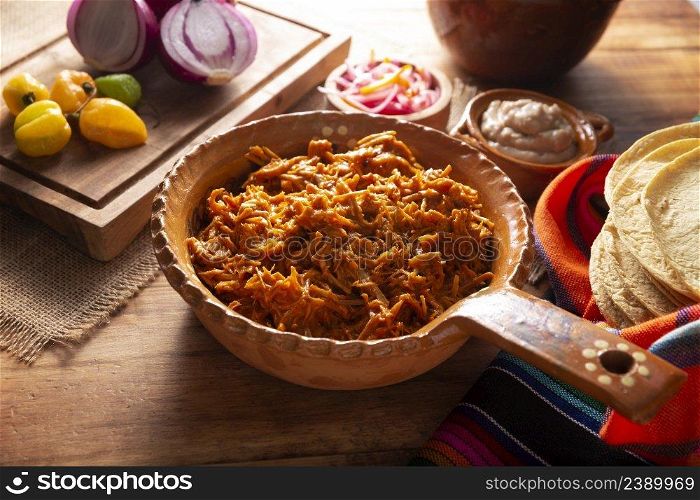 Cochinita Pibil. Typical Mexican stew from Merida, Yucatan, made from pork marinated with achiote and generally accompanied with beans and red onion with habanero chili, it can be eaten in tacos.
