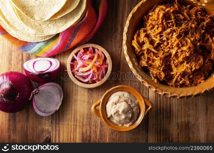 Cochinita Pibil. Typical Mexican stew from Merida, Yucatan, made from pork marinated with achiote and generally accompanied with beans and red onion with habanero chili, it can be eaten in tacos.