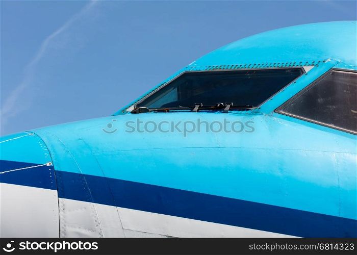 Cockpit close up of blue jet airplane