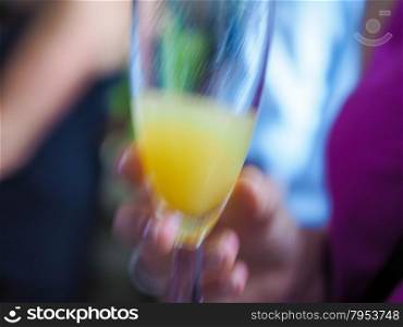 Cocktail blur. Motion blur of cocktail drink glass at a party useful as blurred background
