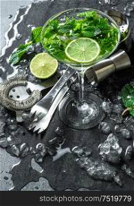 Cocktail drink with lime, mint and ice. Bar accessories
