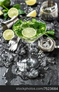 Cocktail drink with lime, mint and ice. Bar tolls and ingredients