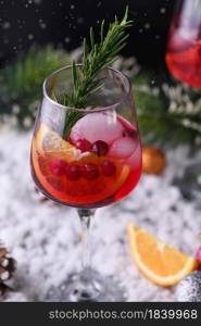 Cocktail Margarita with cranberries, orange and rosemary. A perfect cocktail for a Christmas party