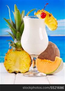 cocktail pina colada with fresh fruits on a beach