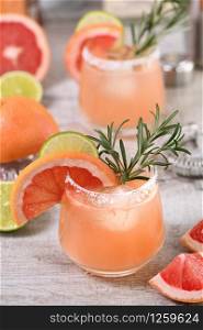 Cocktail pink Palomas fresh lime and rosemary combined with fresh grapefruit juice and tequila. A festive drink is ideal for brunch, parties and holidays.