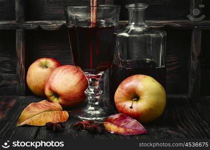 cocktail sangria with apple. Warming autumn cocktail sangria with apple in glass wine glass.Dark key