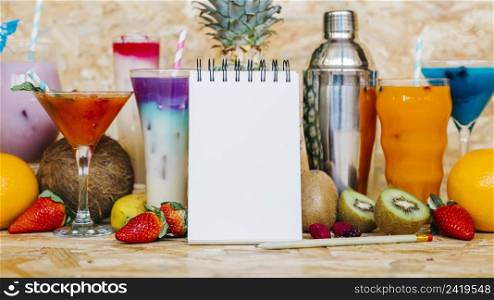 cocktail tropical fruits with blank notepad