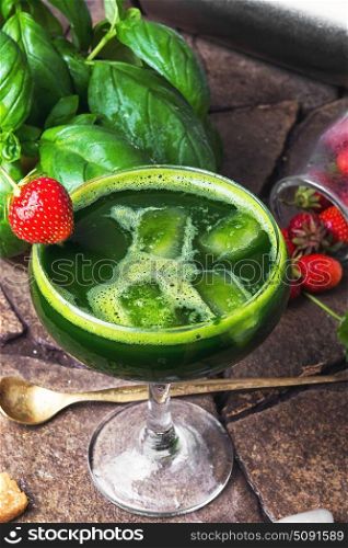 cocktail with basil leaves and strawberry. Basil leaves and strawberry in cold cocktail with alcohol