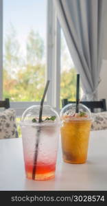 cocktail with fresh sliced fruits . cocktail with fresh sliced fruits arranged in plastic cups