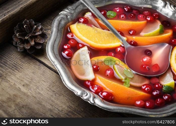 Cocktail with fruits and berries. Alcoholic cocktail with pieces of fruit and berries in a bowl