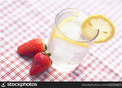 cocktail with ice, lemon and strawberry