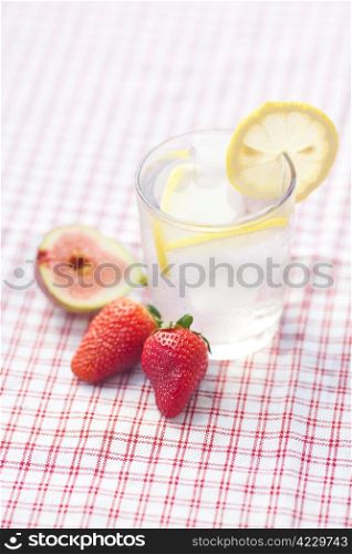 cocktail with ice,lemon, fig and strawberries