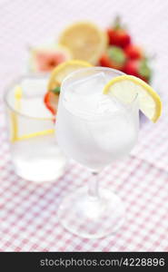 cocktail with ice,lemon, fig and strawberries on a plate