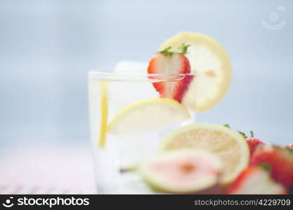 cocktail with ice,lemon, fig and strawberries on a plate